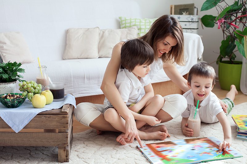Mother playing board game with two children