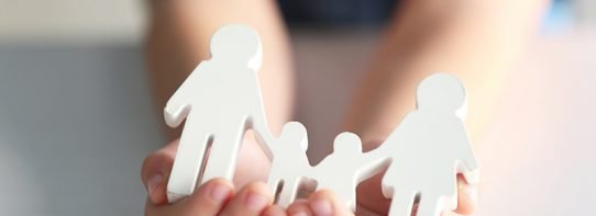 Life Insurance 101 person holding paper family cutouts in hands