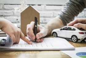 insurance agent signing car insurance policy