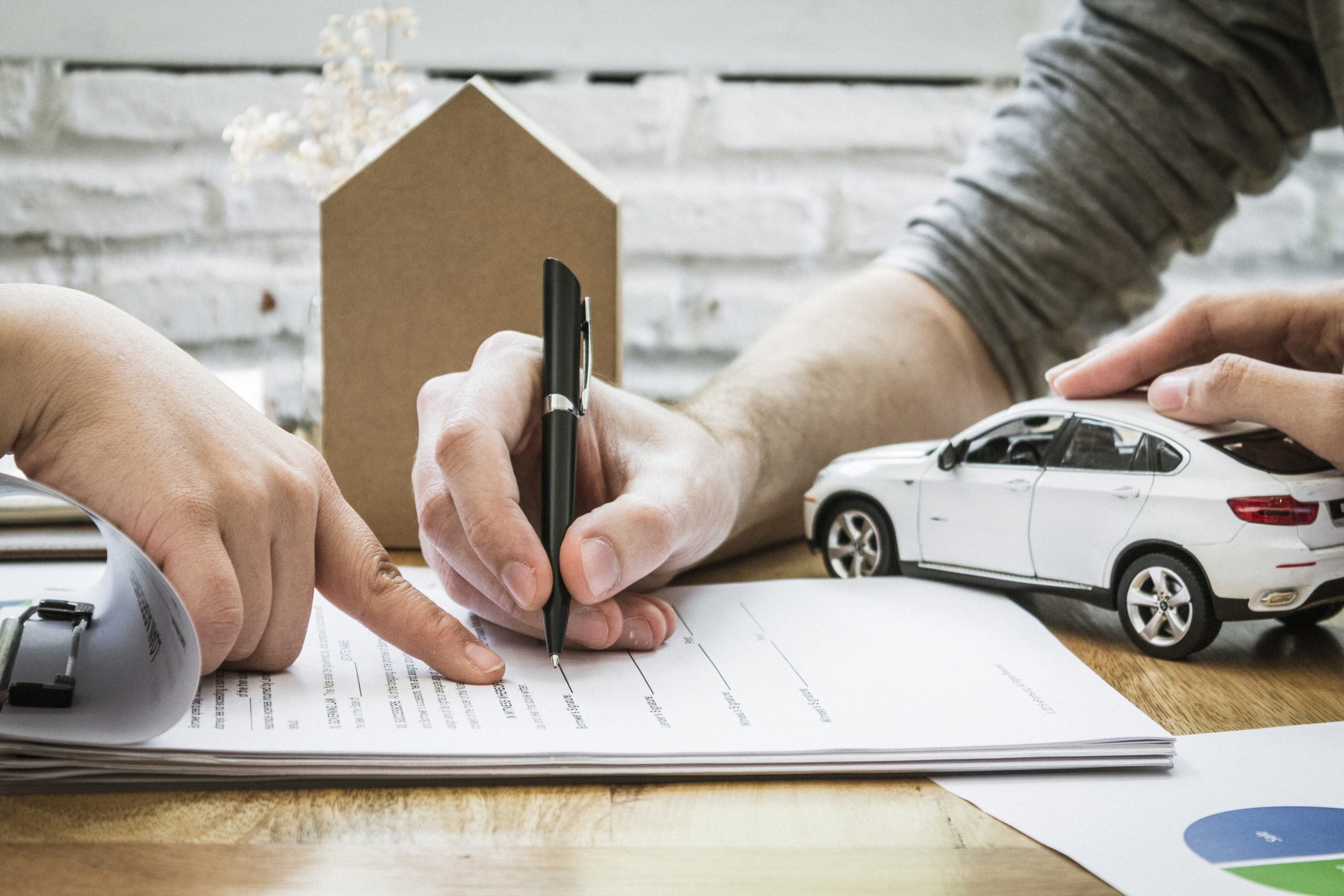 insurance agent signing car insurance policy