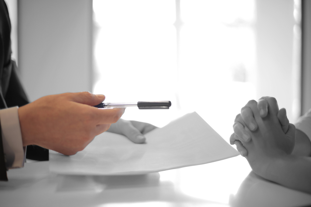 person holding paper and pen