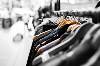 clothes in hangers on a rack